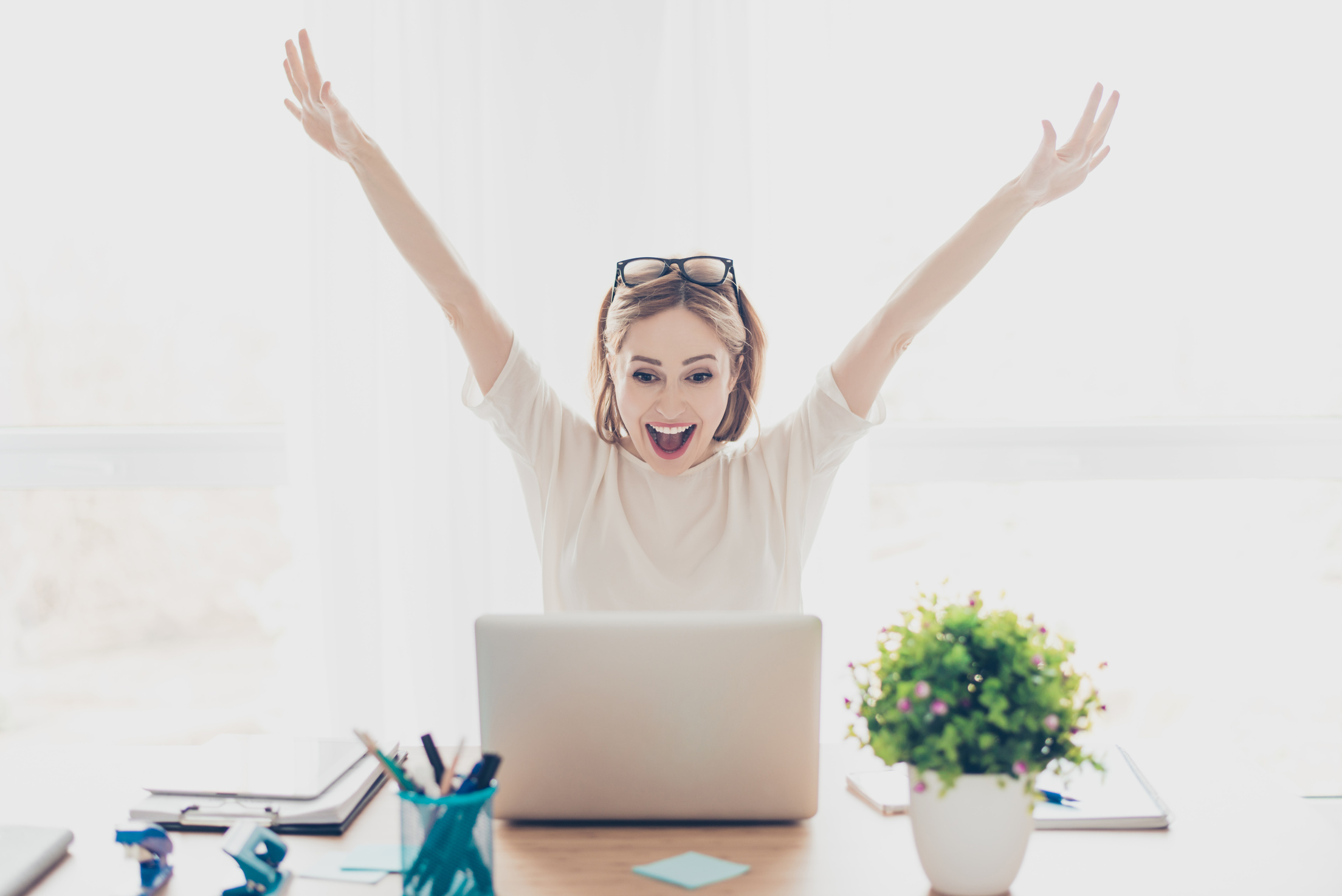 Excited Woman Looking at a Laptop 